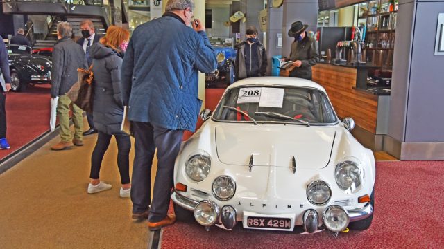 Masked bidder looks over Alpine