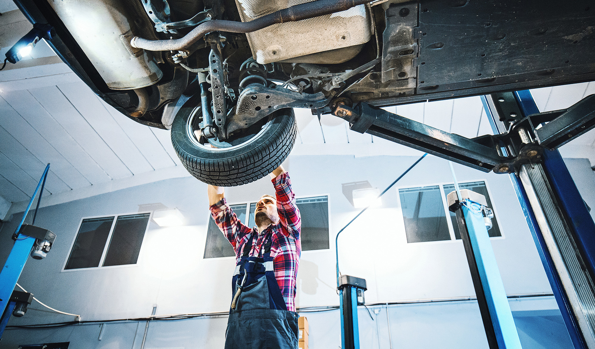Mechanic working on wheel via iStock-504343604