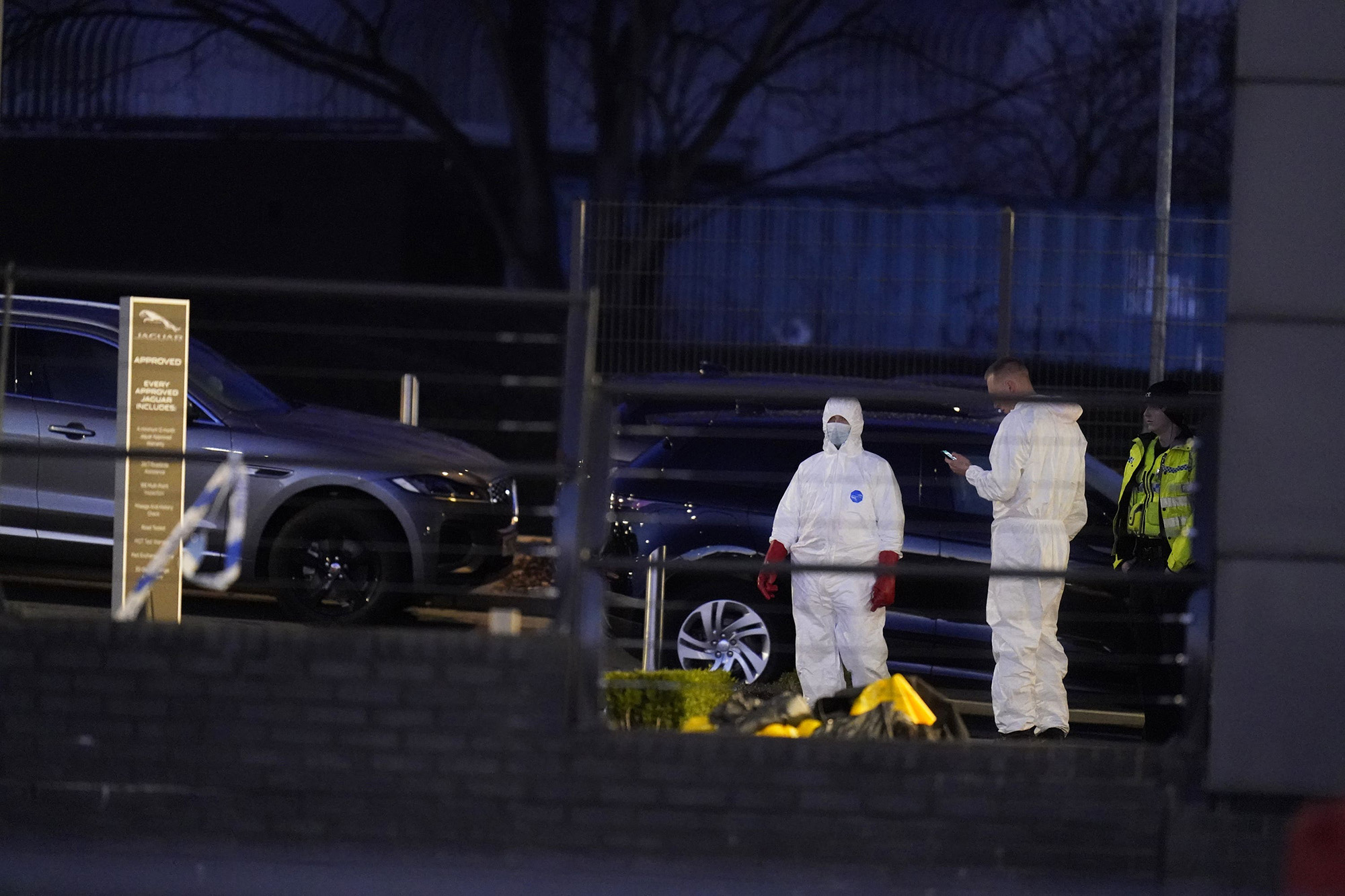 Forensic officers outside the Vertu Jaguar Leeds dealership, via PA